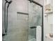 Modern bathroom with glass enclosed shower featuring gray tile and matte black shower head at 1200 Schaub Dr # G, Raleigh, NC 27606