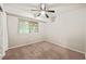 This bedroom is carpeted and has a ceiling fan and a window at 1200 Schaub Dr # G, Raleigh, NC 27606