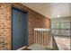 Exterior entrance featuring a blue door, brick detail, and overhead lighting at 1200 Schaub Dr # G, Raleigh, NC 27606