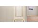 Neutral hallway with tiled floor, rug, and view into a carpeted living space at 1200 Schaub Dr # G, Raleigh, NC 27606