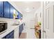 Bright kitchen features blue cabinets, white countertops, and modern appliances at 1200 Schaub Dr # G, Raleigh, NC 27606