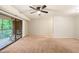 Open living room layout featuring carpeted floor, neutral walls, and sliding glass door to the balcony at 1200 Schaub Dr # G, Raleigh, NC 27606