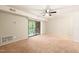 Comfortable living room with carpeted floor, neutral walls, and sliding door access to a balcony at 1200 Schaub Dr # G, Raleigh, NC 27606
