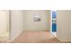 Inviting living room featuring carpeted floor, neutral walls, and kitchen view at 1200 Schaub Dr # G, Raleigh, NC 27606