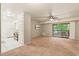 Bright living room featuring carpeted floor, neutral walls, and access to the kitchen and balcony at 1200 Schaub Dr # G, Raleigh, NC 27606