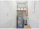 Utility room with water heater and white storage bins on the top shelf at 1200 Schaub Dr # G, Raleigh, NC 27606