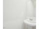 Powder room featuring a classic pedestal sink and mirror at 1205 Solace Way, Rolesville, NC 27571