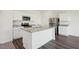 Bright kitchen with white cabinets, stainless steel appliances, and a granite-topped island at 1205 Solace Way, Rolesville, NC 27571