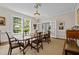 Bright dining room with a chandelier, large windows, and a spacious wooden dining table at 1217 Aycock Ave, Burlington, NC 27215
