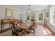 Elegant dining room featuring a chandelier, large windows, and a classic wooden dining set at 1217 Aycock Ave, Burlington, NC 27215