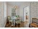 Cozy dining room featuring floral wallpaper, a chandelier, and wood floors at 1217 Aycock Ave, Burlington, NC 27215