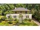 Beautiful home with a symmetrical design, a well-manicured lawn, and mature trees at 1217 Aycock Ave, Burlington, NC 27215