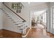 Open foyer showcases hardwood floors, staircase, and an adjacent dining room filled with natural light at 1217 Aycock Ave, Burlington, NC 27215