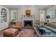 Comfortable living room featuring a fireplace, leather seating, and a patterned rug at 1217 Aycock Ave, Burlington, NC 27215