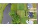 Overhead view of a home with landscaped yard bordering a pond at 1229 Perry Bluff Dr, Wake Forest, NC 27587