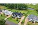 Aerial view of a home with well-manicured landscaping and a backyard pond at 1229 Perry Bluff Dr, Wake Forest, NC 27587