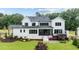 Expansive backyard featuring lush lawn, manicured landscaping, and a charming screened-in porch at 1229 Perry Bluff Dr, Wake Forest, NC 27587