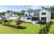 Aerial view of the backyard featuring a lush lawn, beautiful landscaping, and screened-in porch at 1229 Perry Bluff Dr, Wake Forest, NC 27587