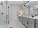 Modern bathroom features double sinks, sleek cabinetry, and a glass-enclosed shower at 1229 Perry Bluff Dr, Wake Forest, NC 27587