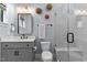 Well-lit bathroom showcasing a vanity, toilet, and a tiled shower with a glass door at 1229 Perry Bluff Dr, Wake Forest, NC 27587