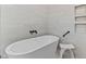 Close-up of a modern bathtub and shower combination, featuring a sleek white soaking tub at 1229 Perry Bluff Dr, Wake Forest, NC 27587