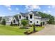 Landscaped front yard, dark trim, white painted brick on a traditional two story home at 1229 Perry Bluff Dr, Wake Forest, NC 27587