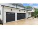 Spacious two-car garage with black doors, offering ample parking and storage at 1229 Perry Bluff Dr, Wake Forest, NC 27587