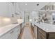 View of a kitchen with white cabinets, stainless steel appliances, and a long island at 1229 Perry Bluff Dr, Wake Forest, NC 27587