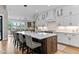 Open concept kitchen with large island, pendant lights, white cabinets and stainless appliances at 1229 Perry Bluff Dr, Wake Forest, NC 27587
