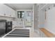 Bright laundry room boasts white cabinetry, stainless steel washer, and a convenient exterior door at 1229 Perry Bluff Dr, Wake Forest, NC 27587