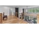 Upstairs loft area with hardwood floors, black iron railing and great natural light at 1229 Perry Bluff Dr, Wake Forest, NC 27587