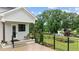 Covered patio with fence overlooking the landscaped backyard and pond at 1229 Perry Bluff Dr, Wake Forest, NC 27587