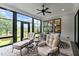 Inviting sunroom featuring comfortable seating and panoramic views of the landscaped backyard at 1229 Perry Bluff Dr, Wake Forest, NC 27587
