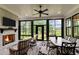 Cozy sunroom with fireplace, large windows, and comfortable seating with a view to the outside at 1229 Perry Bluff Dr, Wake Forest, NC 27587