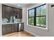Stylish wet bar features dark wood cabinetry, mirrored backsplash and mini-fridge at 1229 Perry Bluff Dr, Wake Forest, NC 27587