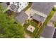 Aerial view of a backyard with a stone fire pit and a screened porch at 128 Low Country Ct, Morrisville, NC 27560