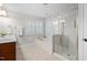 Bright bathroom with a soaking tub, glass shower, and vanity with a sink at 128 Low Country Ct, Morrisville, NC 27560