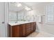Bathroom featuring a double sink vanity with dark wood cabinets and modern fixtures at 128 Low Country Ct, Morrisville, NC 27560