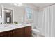 Bathroom with a double sink vanity, tub and shower combo, and natural lighting at 128 Low Country Ct, Morrisville, NC 27560