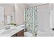 Charming bathroom featuring a tub with shower, colorful curtain, and modern sink with vanity at 128 Low Country Ct, Morrisville, NC 27560