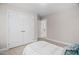 Bedroom with a closet featuring double doors and neutral carpeting at 128 Low Country Ct, Morrisville, NC 27560