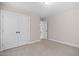Bedroom with a closet featuring double doors and neutral carpeting at 128 Low Country Ct, Morrisville, NC 27560