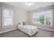 Well-lit bedroom featuring neutral walls, carpet, and large windows at 128 Low Country Ct, Morrisville, NC 27560
