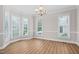 Elegant dining room with bay windows, a chandelier, and hardwood floors at 128 Low Country Ct, Morrisville, NC 27560
