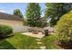 Backyard firepit featuring stone seating, a secure fence, and lush green landscaping at 128 Low Country Ct, Morrisville, NC 27560