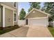 Attached two-car garage featuring a side entrance and large driveway at 128 Low Country Ct, Morrisville, NC 27560