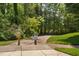 Community greenway entrance surrounded by lush greenery and natural landscape at 128 Low Country Ct, Morrisville, NC 27560
