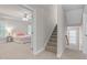 Hallway and bedroom with staircase featuring neutral walls and carpet at 128 Low Country Ct, Morrisville, NC 27560