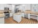 Modern kitchen featuring white cabinets, stainless steel appliances, and granite countertops at 128 Low Country Ct, Morrisville, NC 27560