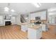 Open kitchen with large island, granite counters, and stainless appliances at 128 Low Country Ct, Morrisville, NC 27560